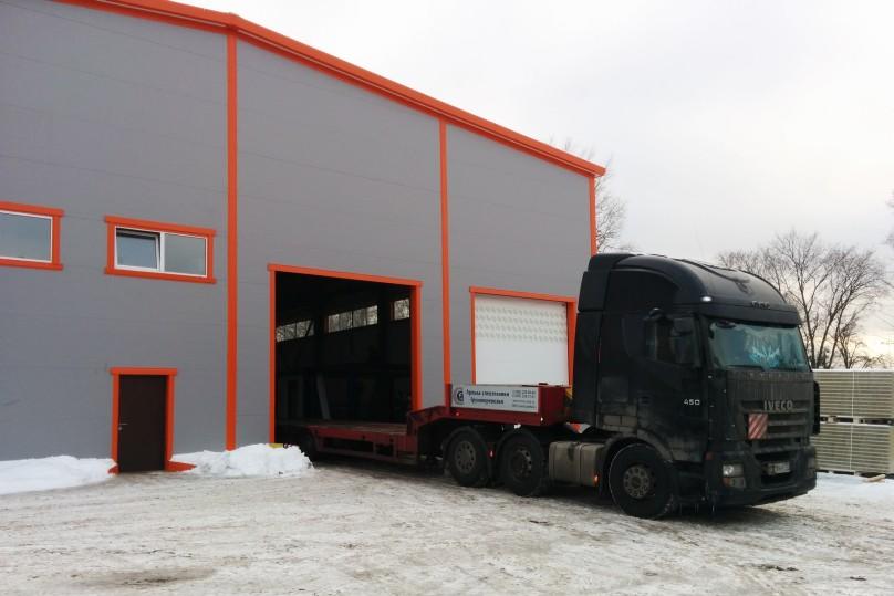 A lengthy truck entering the workshop