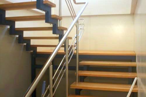 Фото Staircase with wooden steps and stainless steel handrails