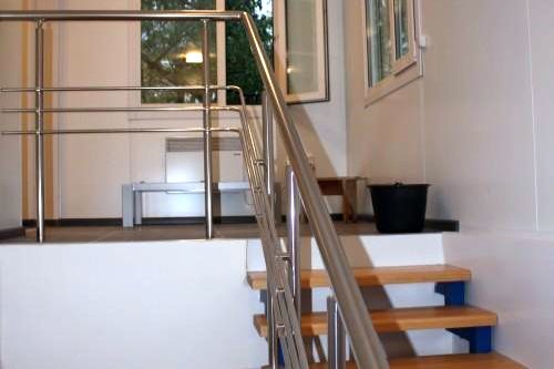 Фото Staircase with wooden steps and stainless steel handrails