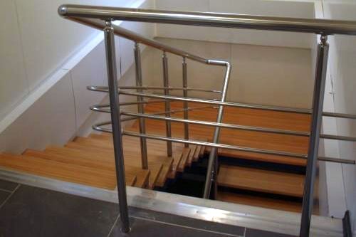 Фото Staircase with wooden steps and stainless steel handrails